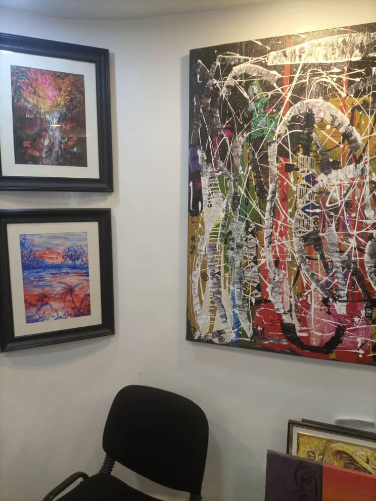 Framed prints beside a large abstract