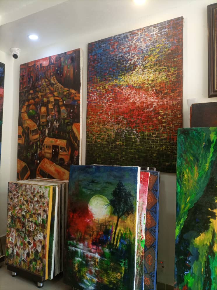 Showroom corner with stacked canvases
