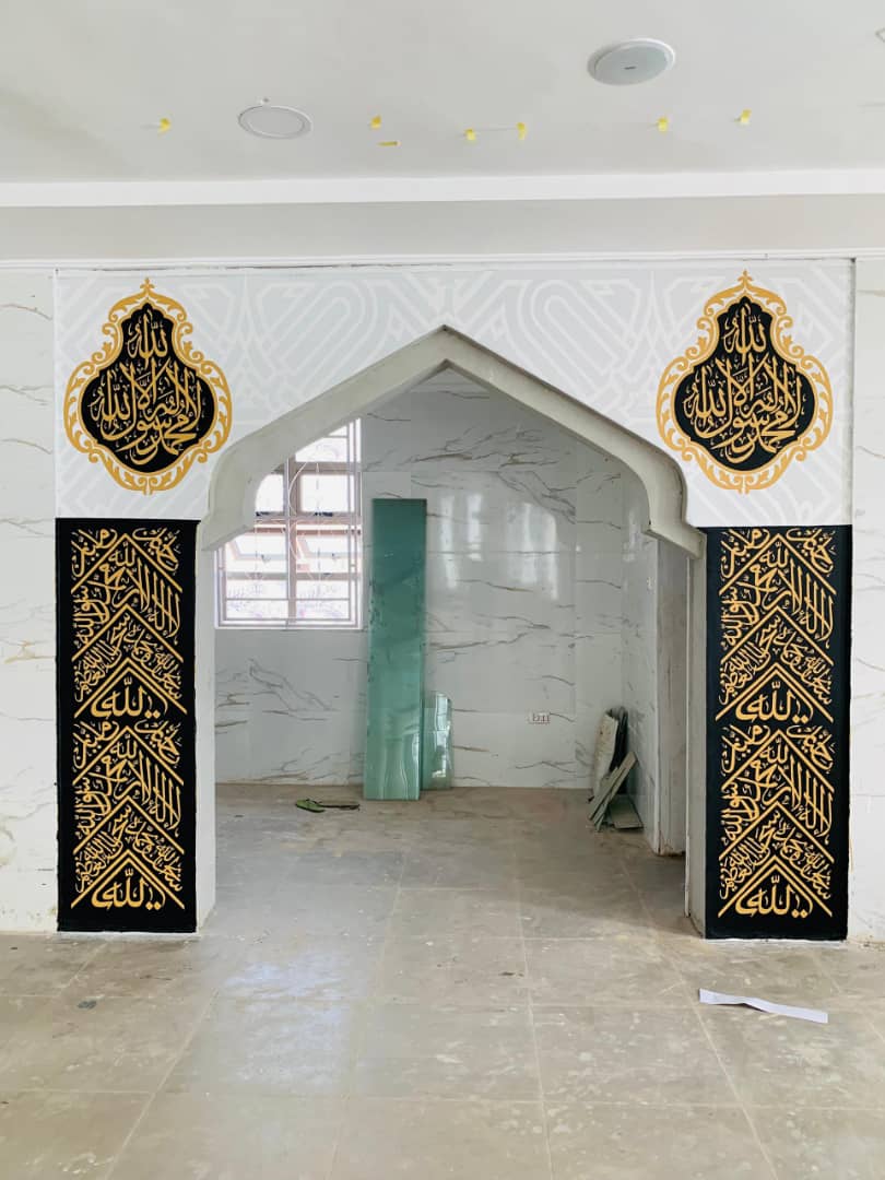 Arched doorway with gold calligraphy panels