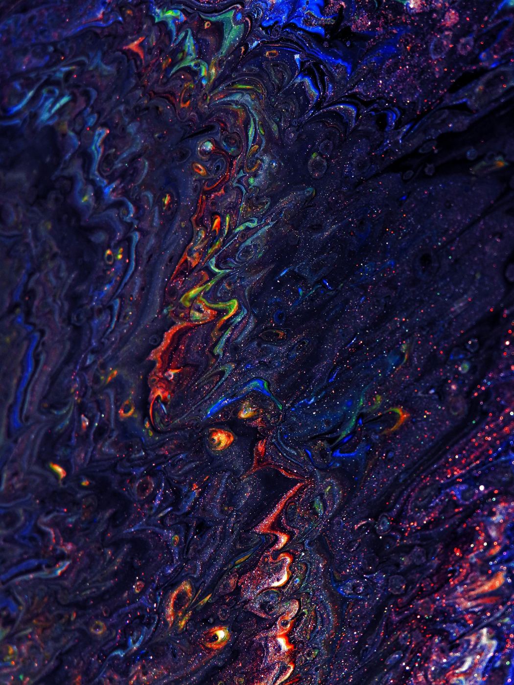 Swirling ink in deep blue and red